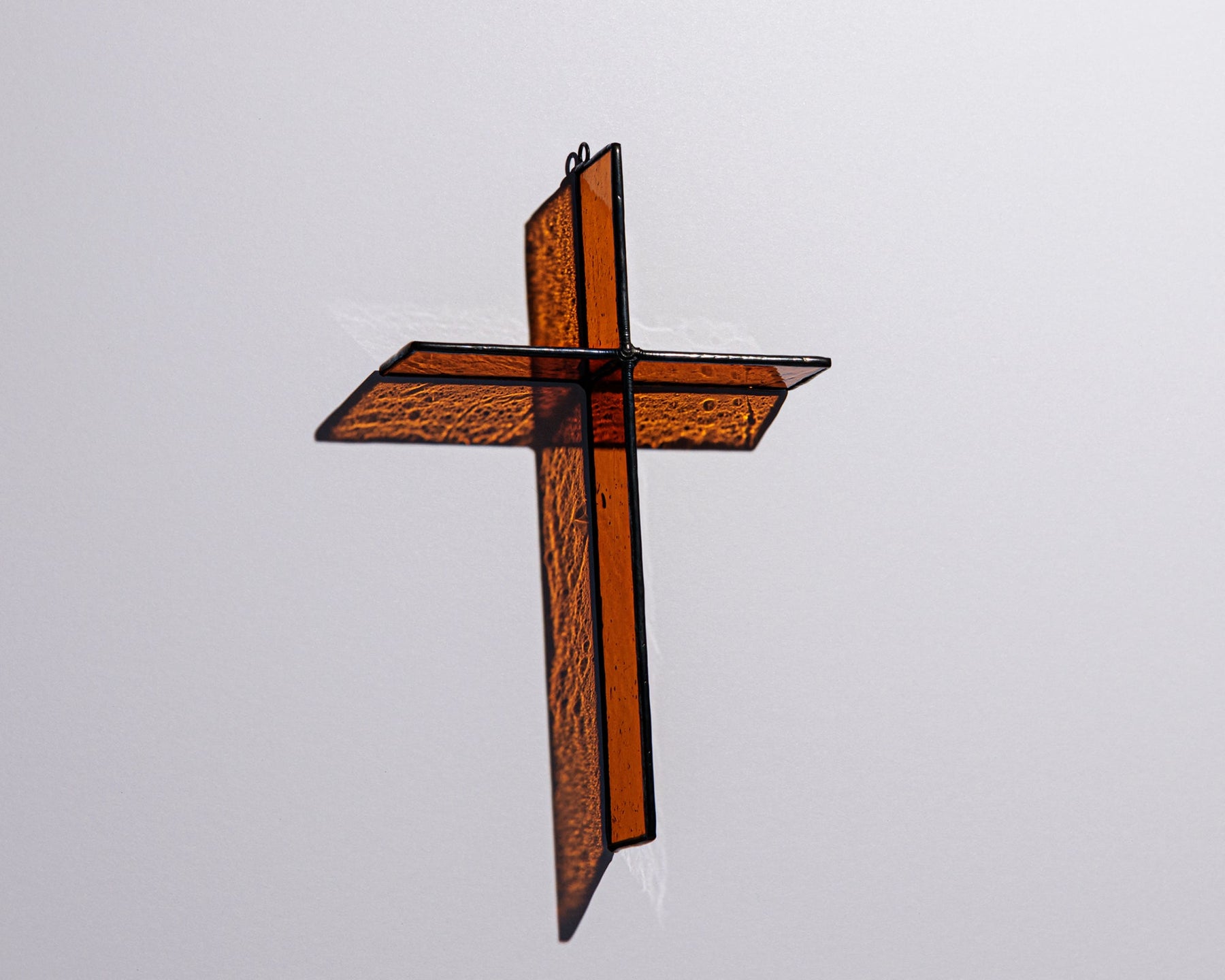 Alternate view of Harvest Orange Cross Suncatcher with real stained glass and black patina