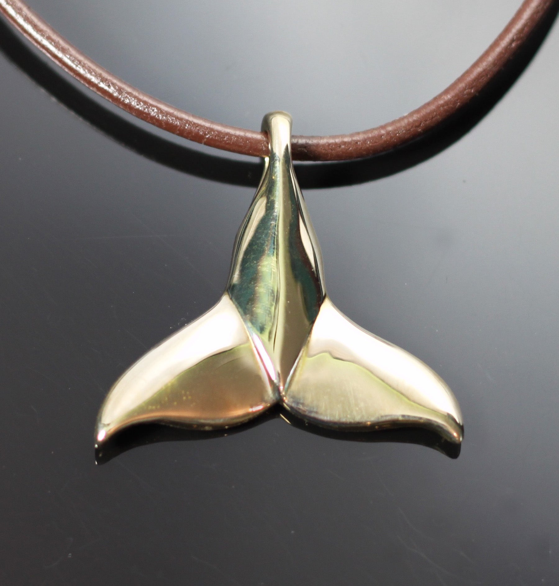 Bronze Dolphin Tail Pendant on Brown Leather Cord by Anisa Jewelry