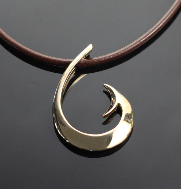 Reversible bronze circle hook pendant with verde patina on leather cord