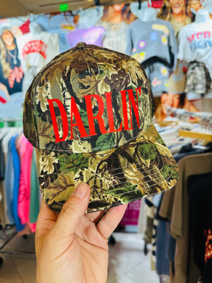 Darlin' (red font) Real Camo Canvas Trucker Hat detail view by Southern Bliss Company