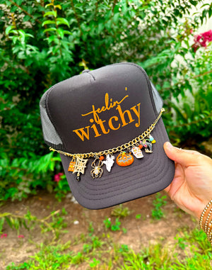 Feelin' Witchy (orange font) Black Trucker detail view by Southern Bliss Company