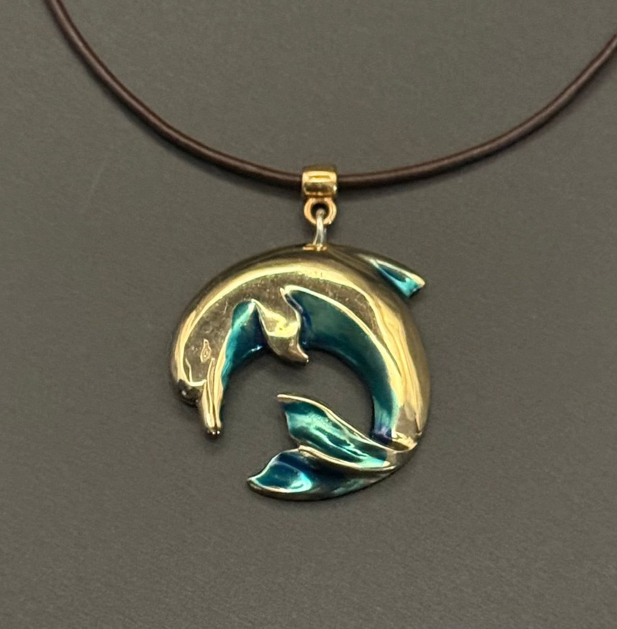 Bronze Curved Dolphin Pendant with Blue Patina by Anisa Jewelry
