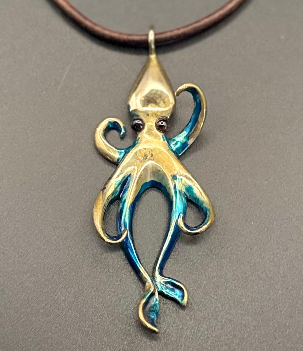 Large Bronze Squid Pendant with Blue Patina and Garnet Eyes detail view by Anisa Jewelry