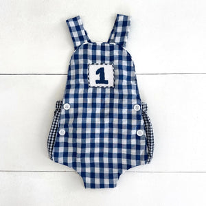 Navy Blue Smocked First Birthday Sunsuit by Seven Lantern Lane, children's boutique clothing main product photo