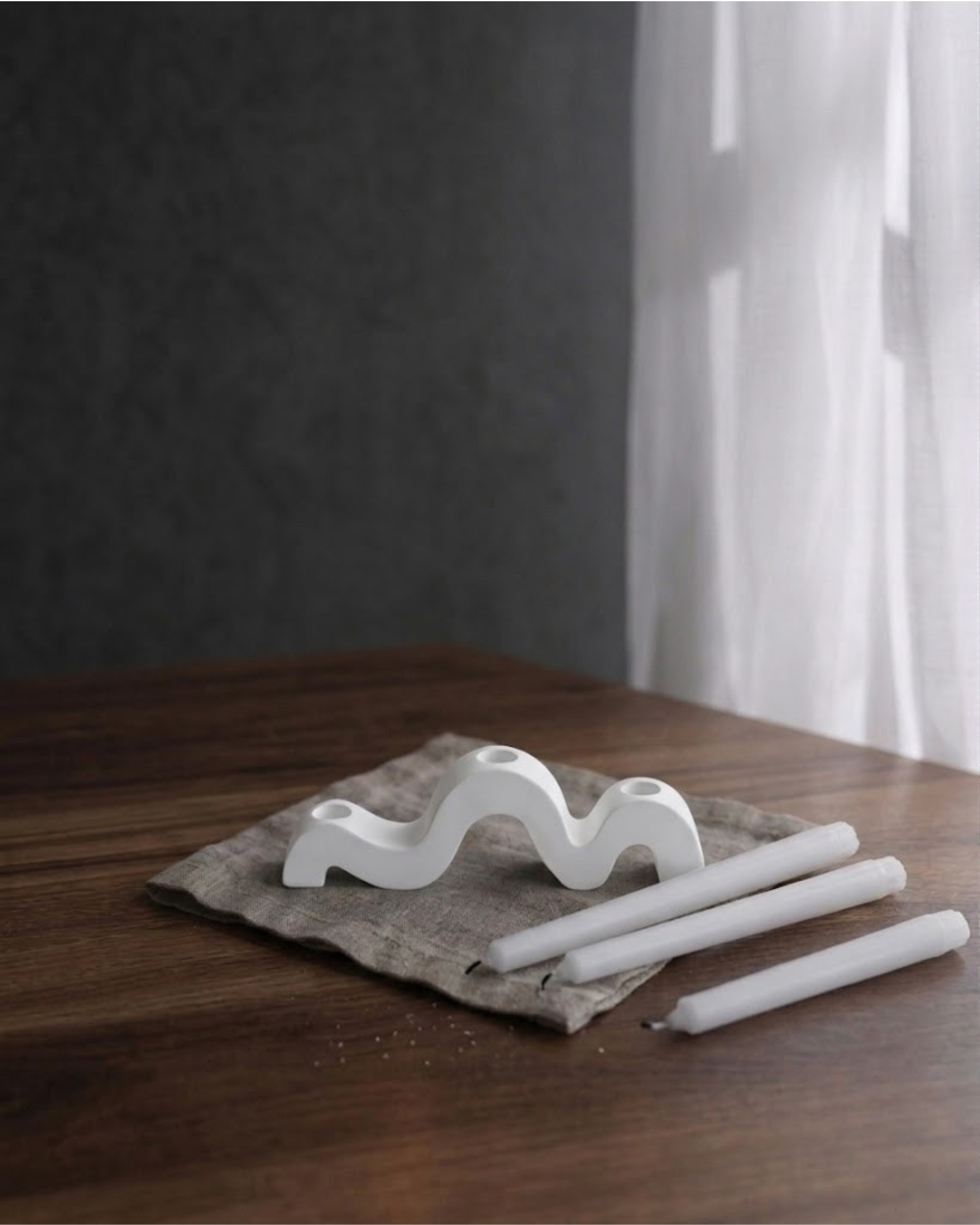 Handcrafted white wave taper candle holder styled as modern home decor