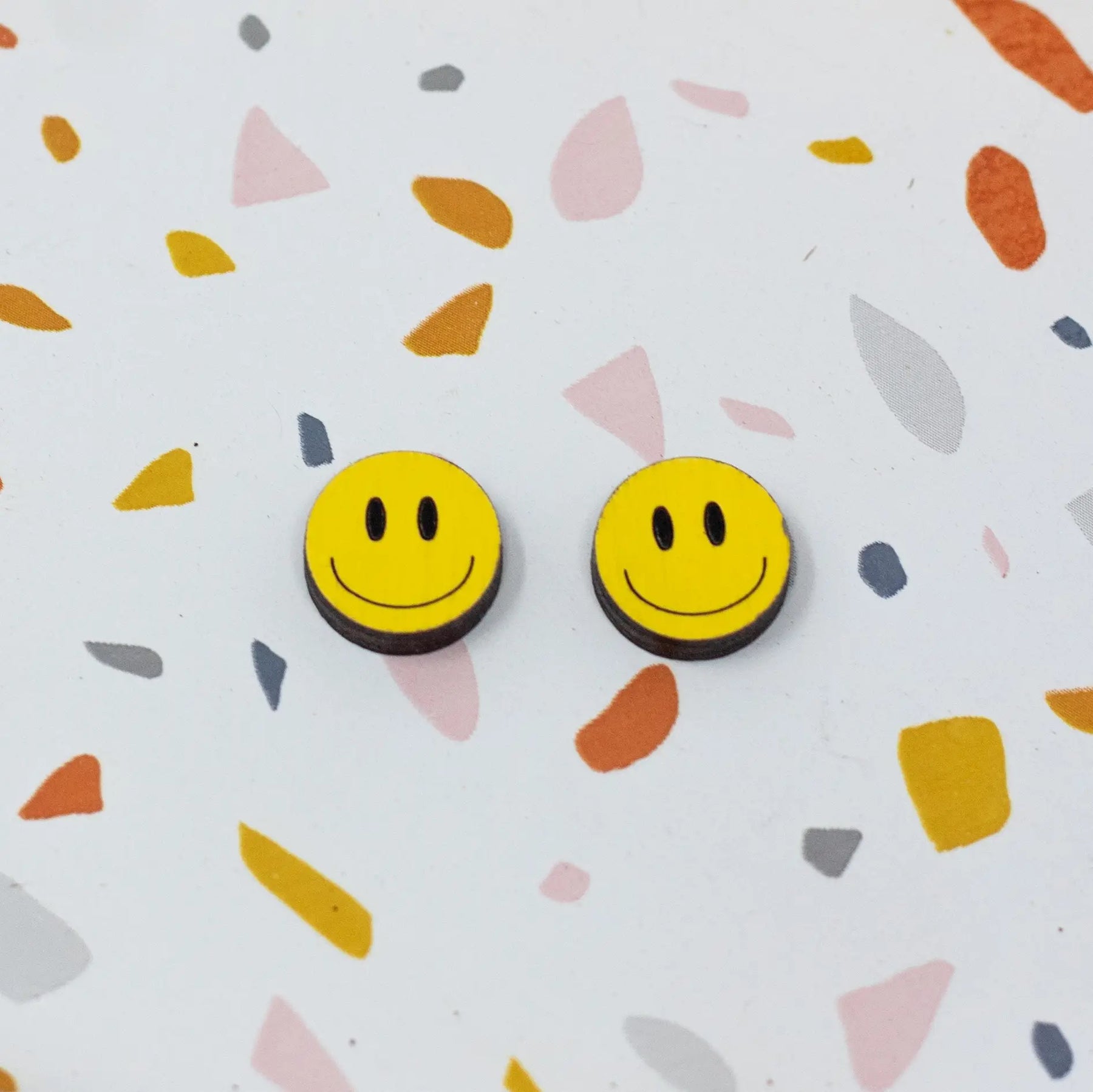 Additional view of Happy Face Stud Earrings, 3 Colors Available hand painted on lightweight wood by LE CHIC MIAMI