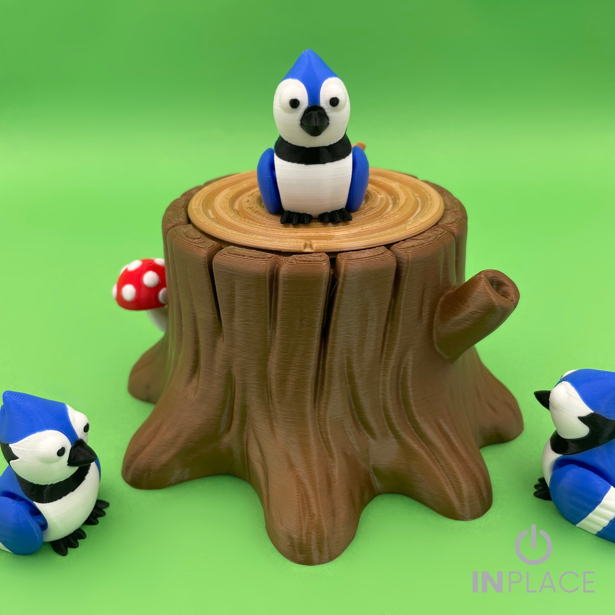 Blue jay tree stump playset with three birds on a green background
