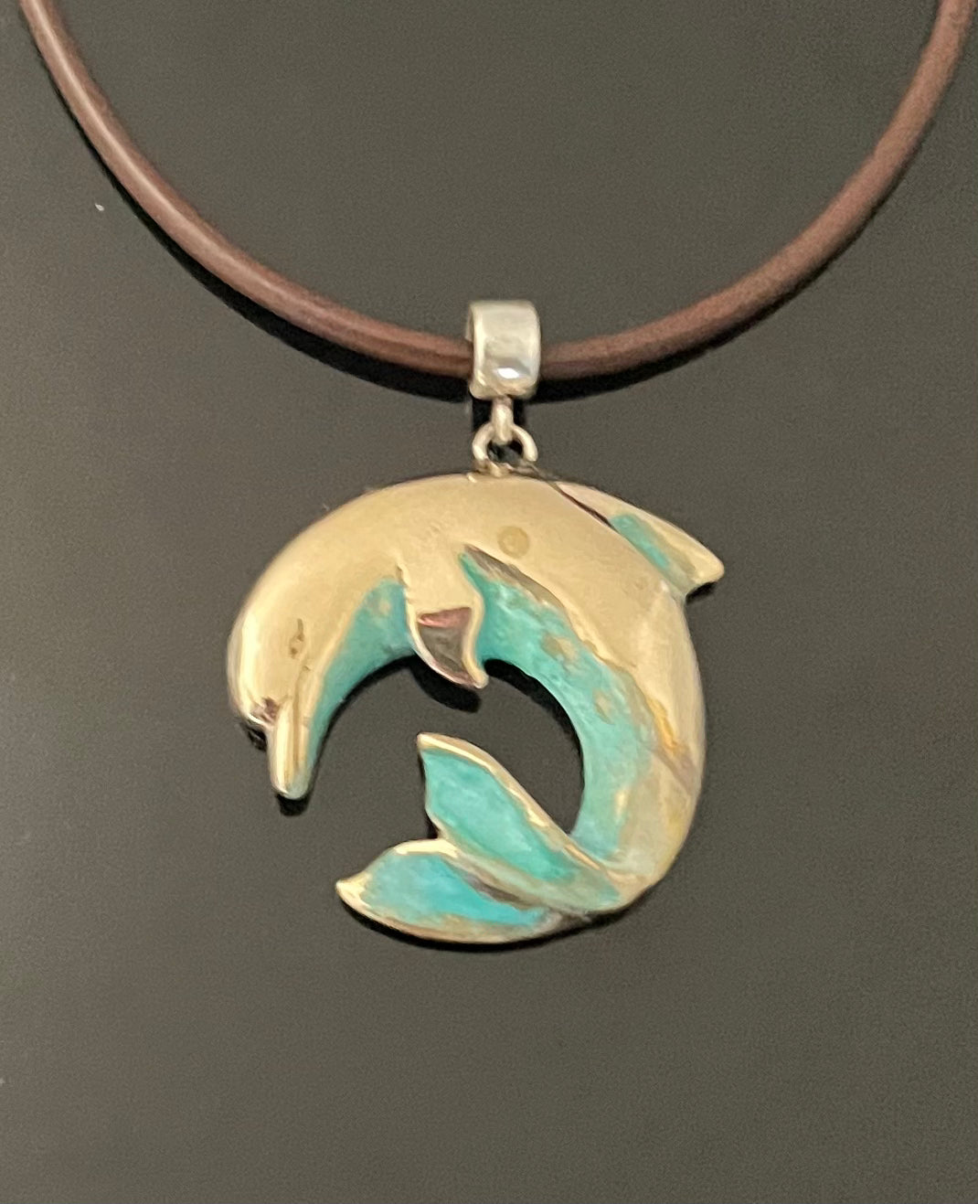 Bronze Curved Dolphin Pendant with Verde Patina by Anisa Jewelry