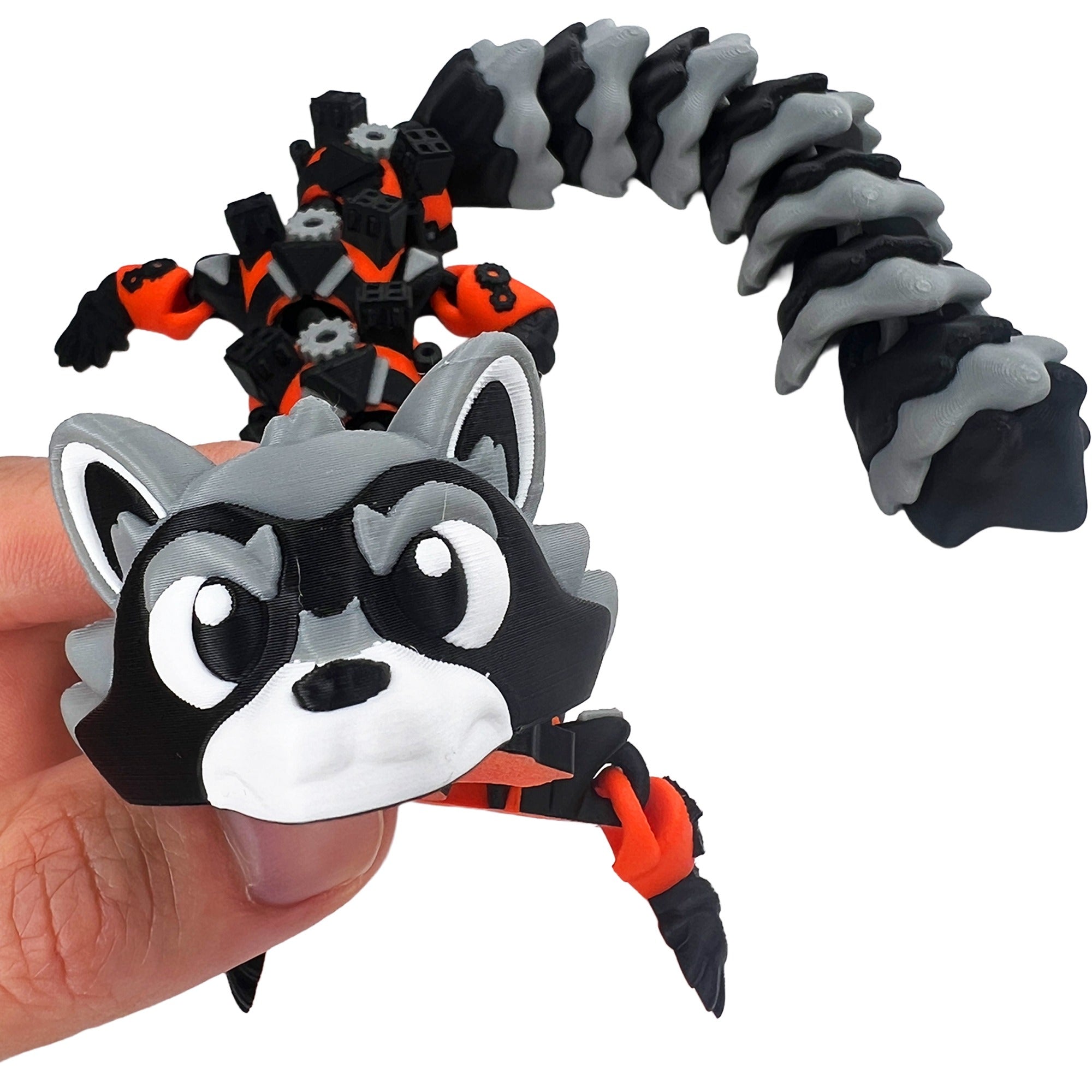 Close-up of Star Bandit Dragon articulated 3D printed toy with masked raccoon-inspired face and striped tail